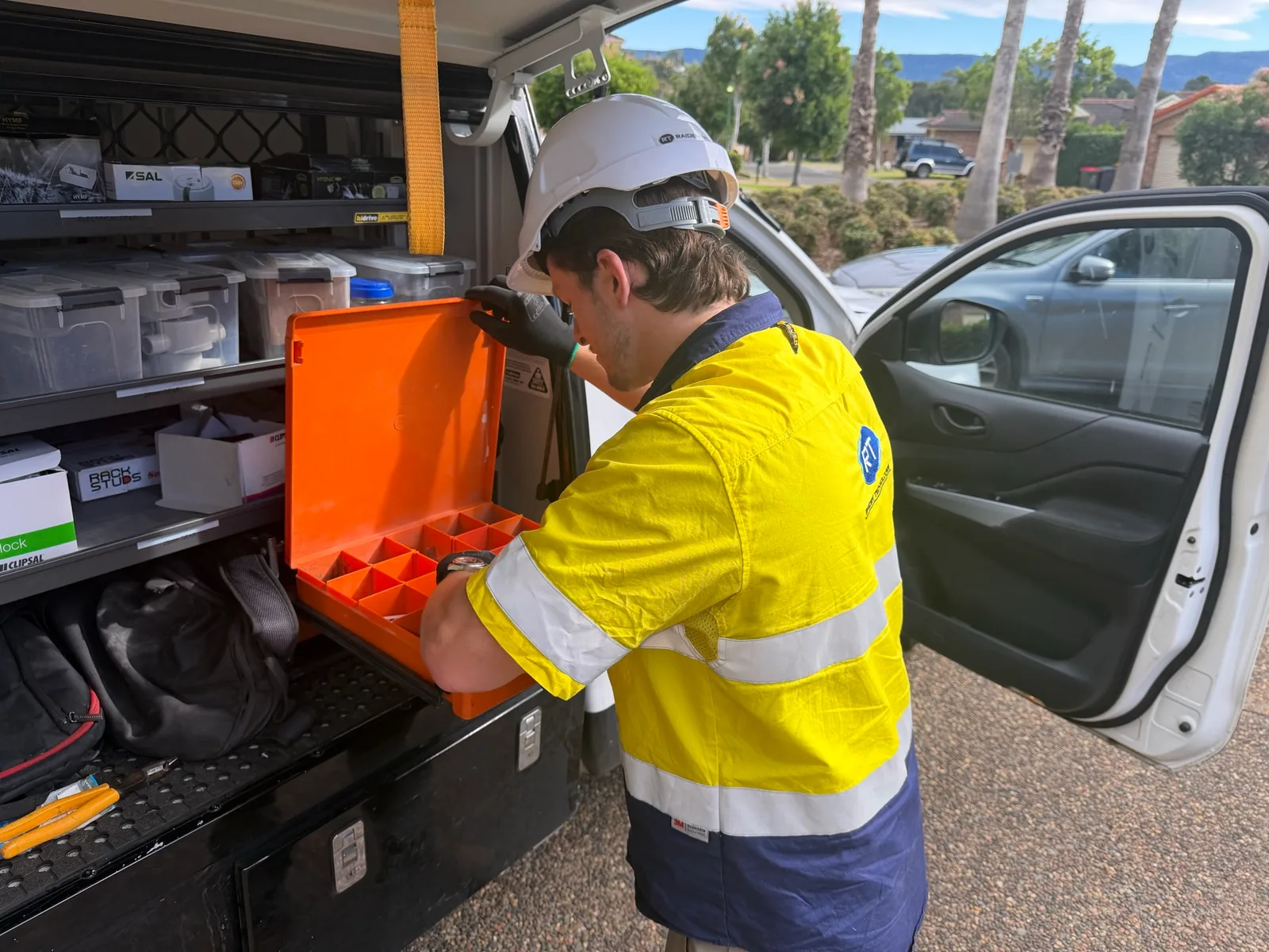Raiden Technologies technician preparing security and electrical components for commercial delivery
